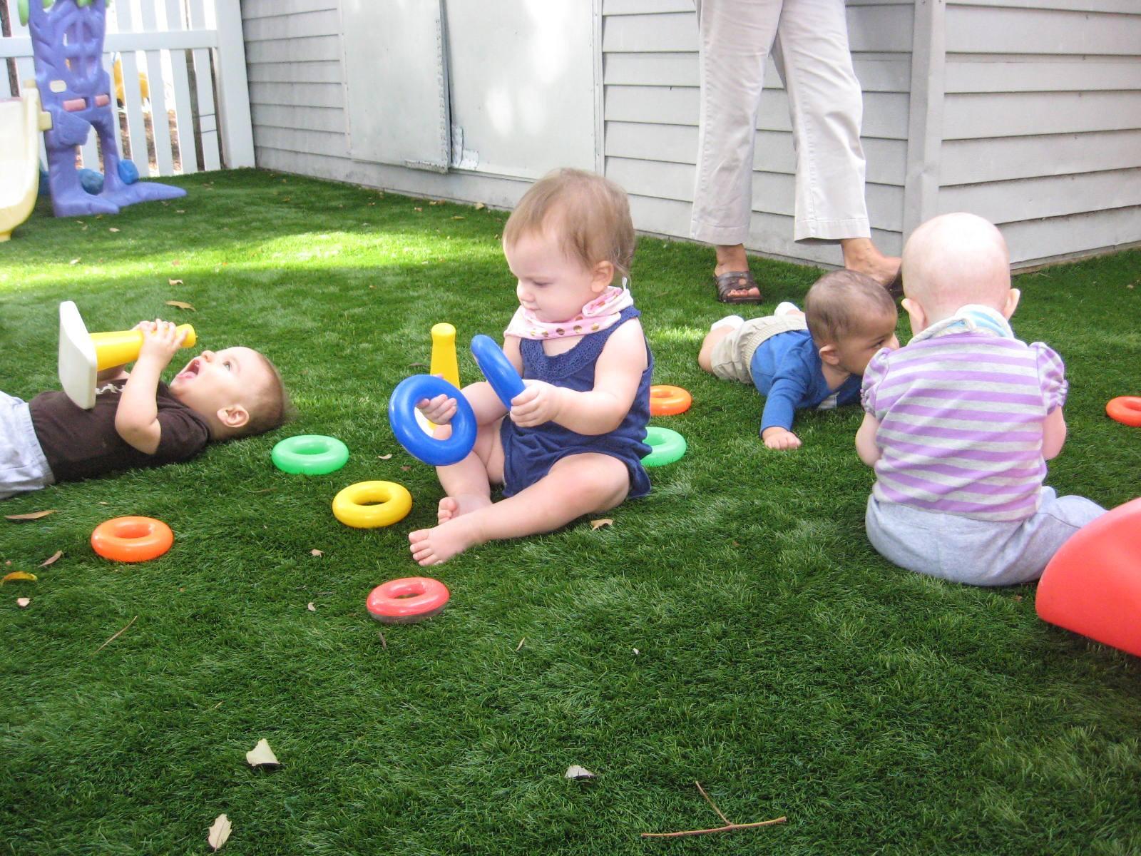 Infants playing in an outdoor yard at Toad Hall